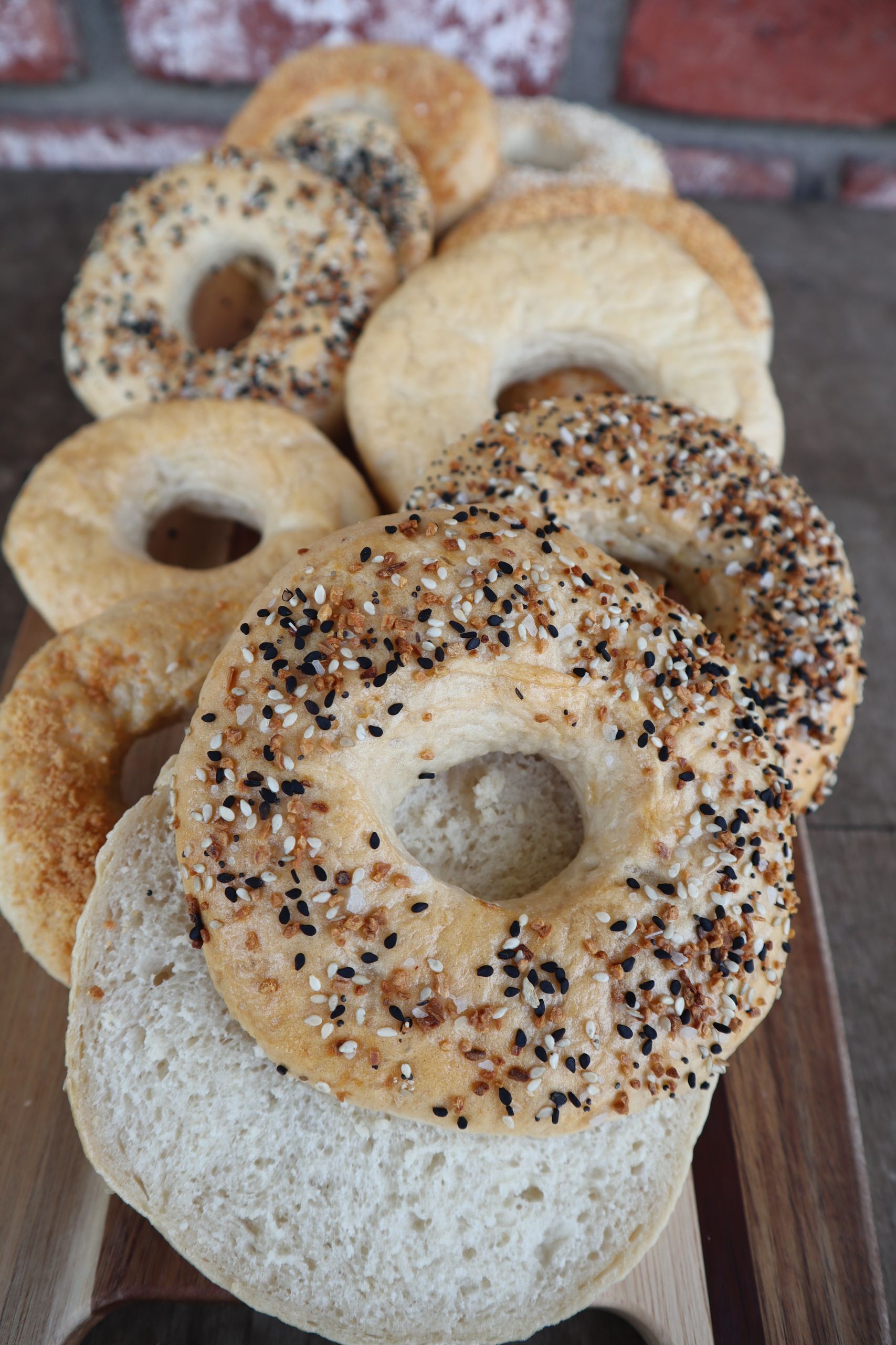 Delicious assortment of bagels with seeds, sliced and ready to enjoy.